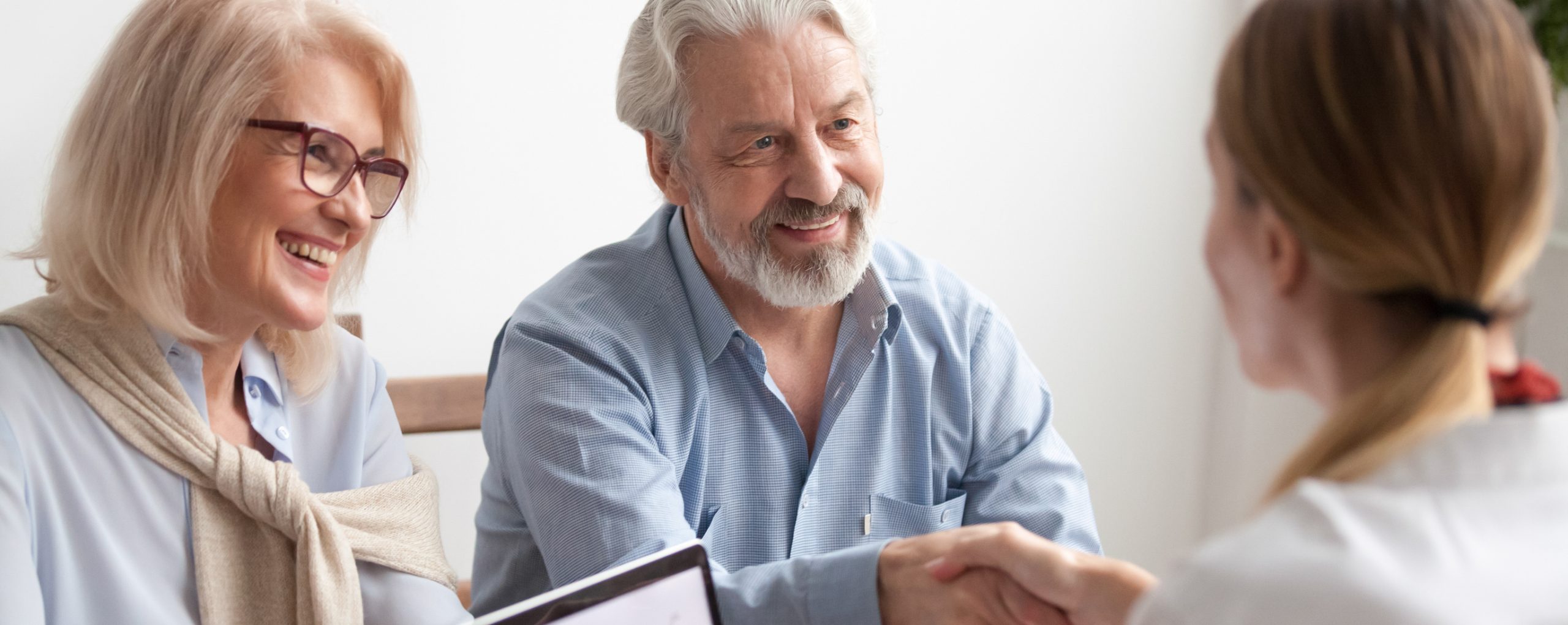 Horizontal photo positive mature spouses buying property feels happy shaking hands with real estate broker agent Real Estate Agent female, loan mortgage home purchase concept, banner for website header design