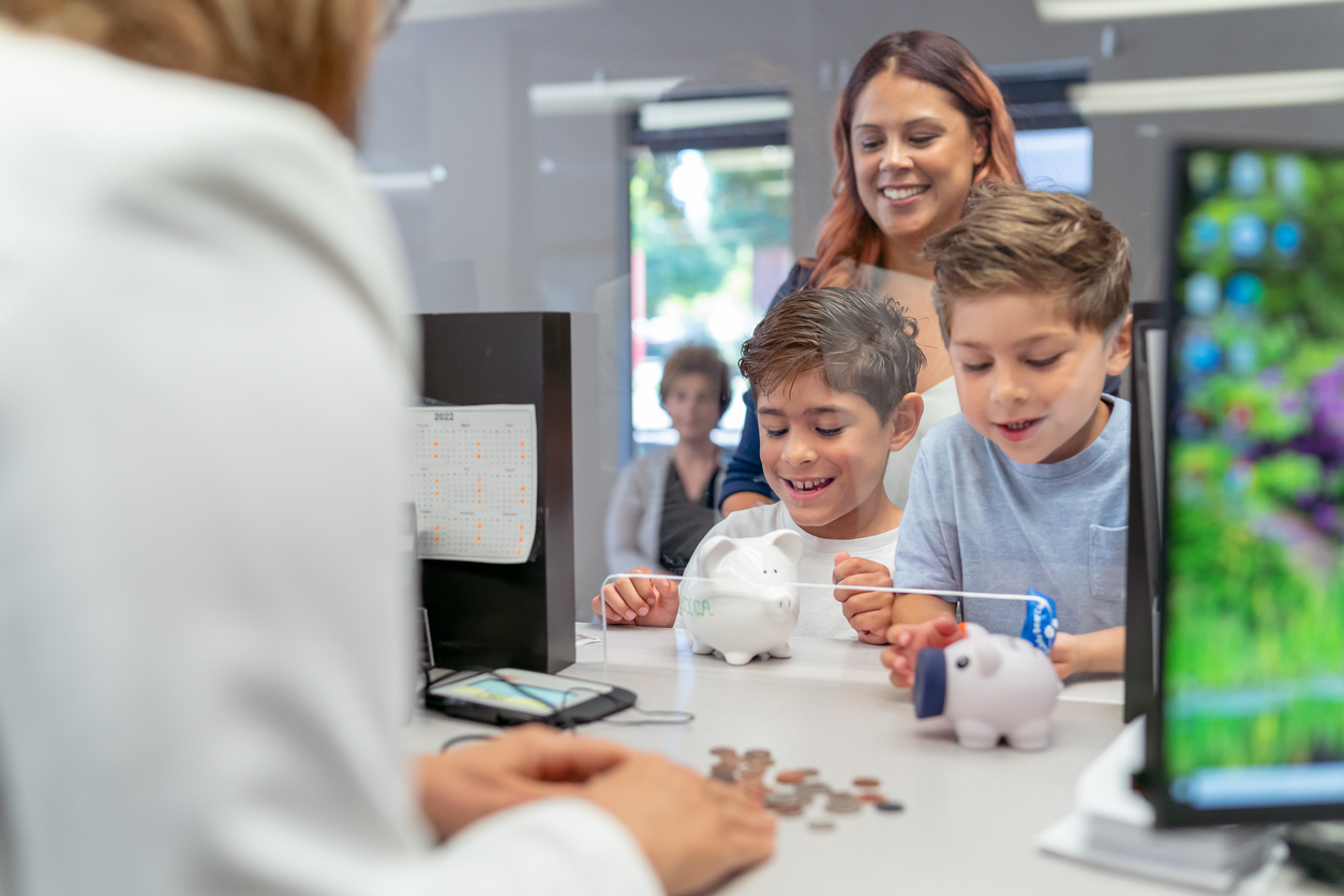 Children with Piggy Bank depositing into savings accounts